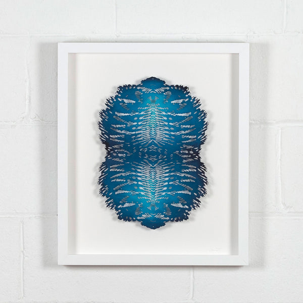 Lizz Aston, Blue Apatite, Hand cut paper, 2018, Caviar 20, shown framed and displayed on white brick wall