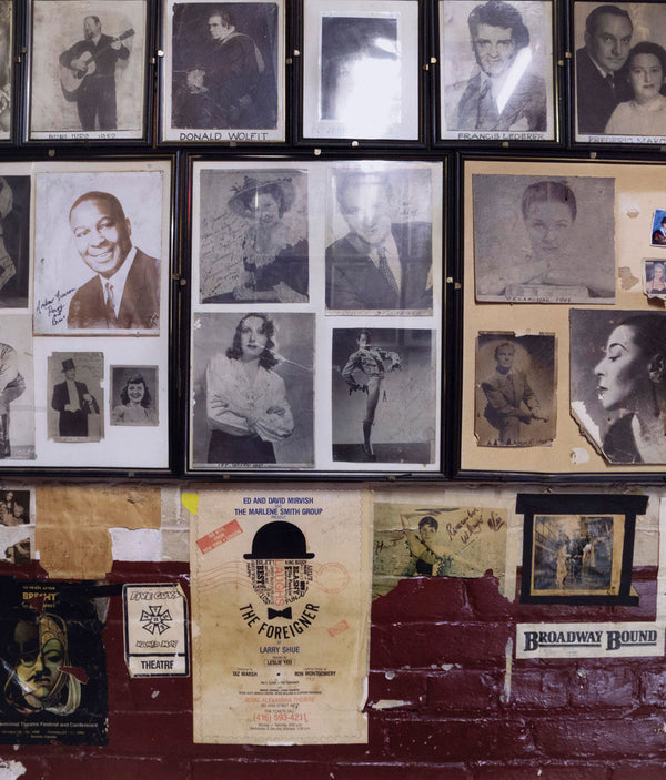 Edward Burtynsky "The Royal Alexandra Theatre Portfolio, 2007” Canada, 2007. Chromogenic print. In this image, Burtynsky captures the details of a collage made of historical cast photos backstage. The wall is covered with headshots and clippings of famous alumni who have performed at the theatre over the years. Below the portraits is a collection of posters from past productions including the musical Les Misérables and a festival devoted to Brecht. 