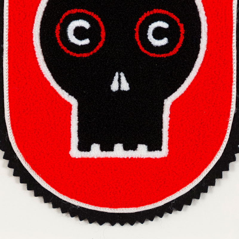 General Idea "Eye of the Beholder" Chenille crest, 1989. Editioned series by Famous Canadian artist trio, which features their iconic skull motif against a florescent red background.