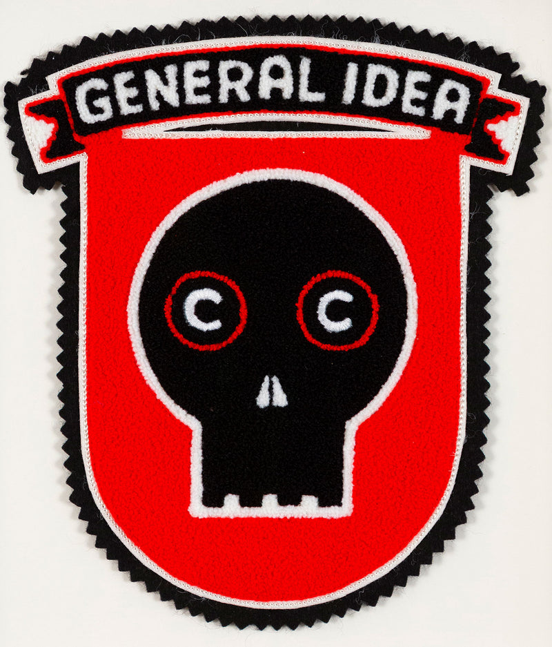 General Idea "Eye of the Beholder" Chenille crest, 1989. Editioned series by Famous Canadian artist trio, which features their iconic skull motif against a florescent red background.