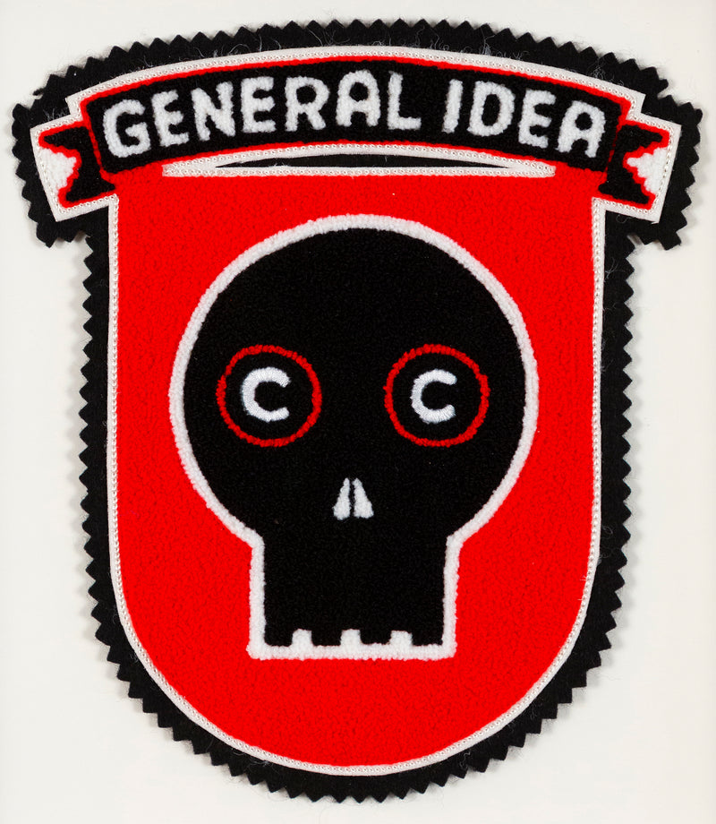 General Idea "Eye of the Beholder" Chenille crest, 1989. Editioned series by Famous Canadian artist trio, which features their iconic skull motif against a florescent red background.