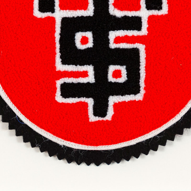 General Idea "Lucre" Chenille Crest, 1989. Editioned textile art by famous Canadian artist trio, which features three dollar signs set against a florescent red background.