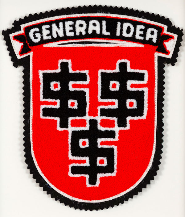 General Idea "Lucre" Chenille Crest, 1989. Editioned textile art by famous Canadian artist trio, which features three dollar signs set against a florescent red background.