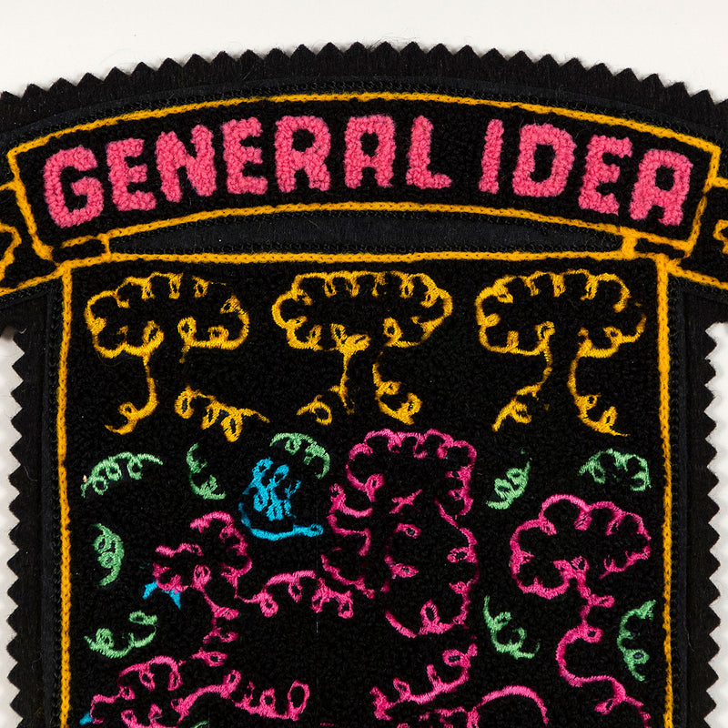 General Idea "When Fur Flies" Chenille crest, 1988. Embroidered crest featuring a whimsical poodle silhouette in neon shades of orange, pink, and blue.