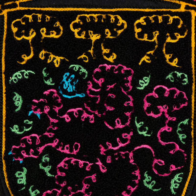 General Idea "When Fur Flies" Chenille crest, 1988. Embroidered crest featuring a whimsical poodle silhouette in neon shades of orange, pink, and blue.