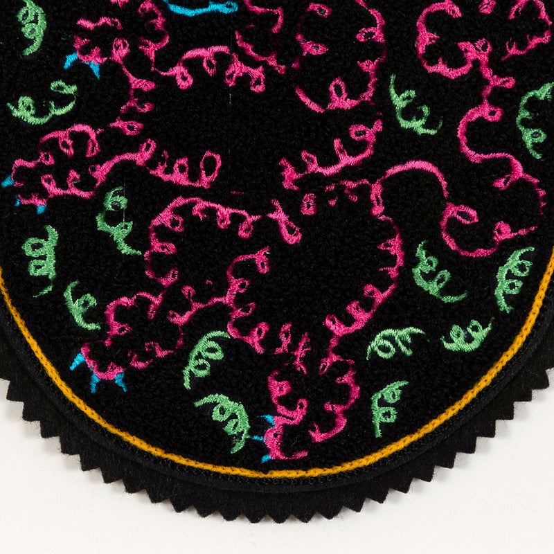 General Idea "When Fur Flies" Chenille crest, 1988. Embroidered crest featuring a whimsical poodle silhouette in neon shades of orange, pink, and blue.