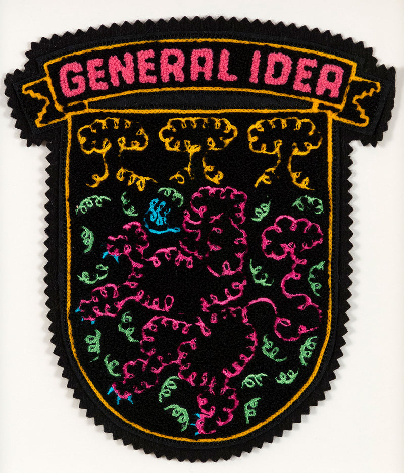General Idea "When Fur Flies" Chenille crest, 1988. Embroidered crest featuring a whimsical poodle silhouette in neon shades of orange, pink, and blue.
