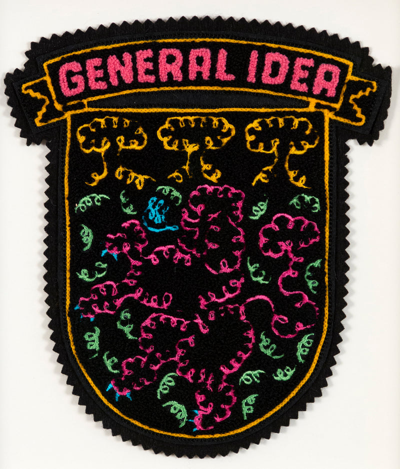 General Idea "When Fur Flies" Chenille crest, 1988. Embroidered crest featuring a whimsical poodle silhouette in neon shades of orange, pink, and blue.
