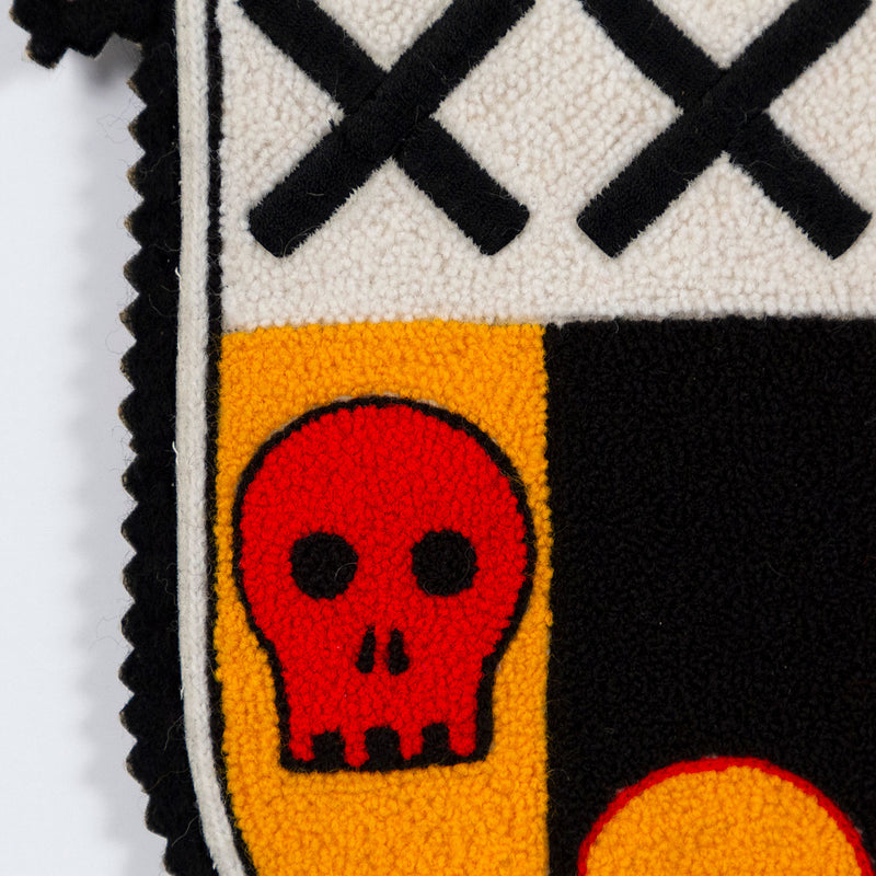 General Idea "Post Mortem" Chenille crest, 1988. Textile patch featurings a trio of skulls and alternating shades of yellow, red, and black.