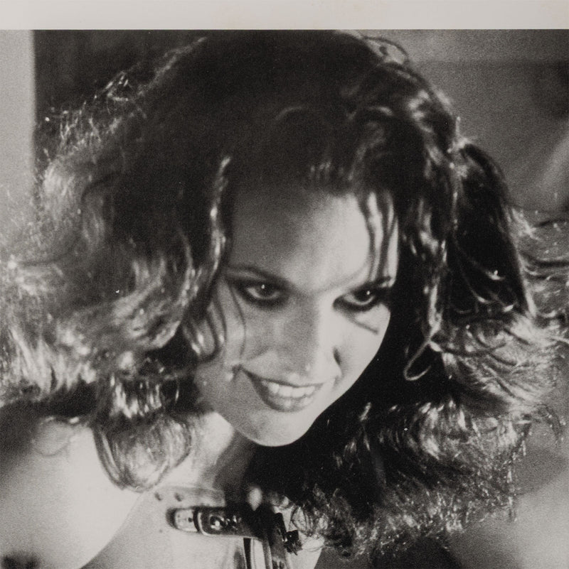 Black and white close up of a woman smirking