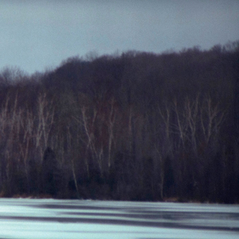 Nature and lanscape photography featuring a frozen lake and winter forest by Peter Doig "Across the Lake" C-print, 2000. 