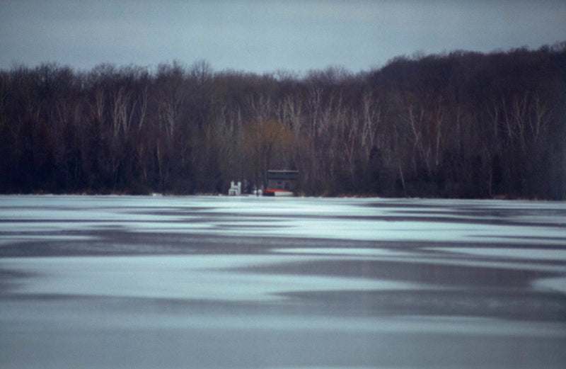 Peter Doig "Across the Lake" C-print, 2000.  Winter landscape and nature photography featuring a frozen lake and a forest of leafless trees.