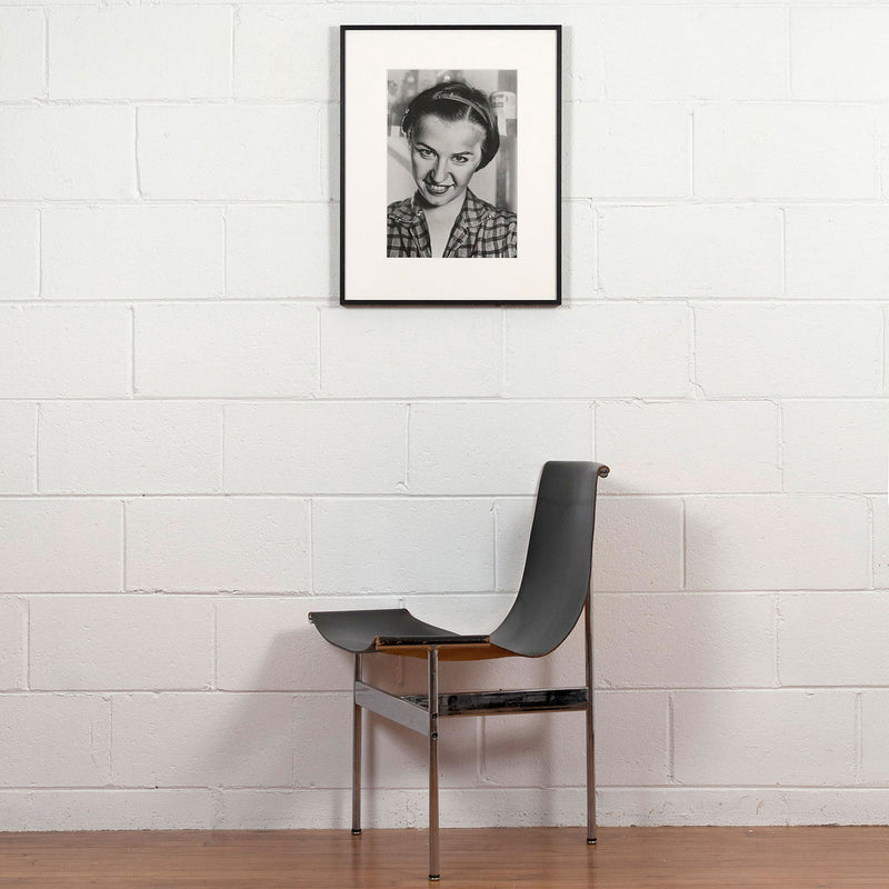 Cindy Sherman, Untitled, Photograph, 1975, Caviar 20, shown displayed in frame on white brick wall with Eames chair