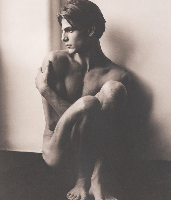 Herb Ritts "Stefano Seated" Platinum print photograph, 1985. “Stefano Seated” is a wonderful example of Ritts’ ability to capture polished intimacy. The subject appears relaxed in the nude yet holds a modelesque grace posing with awareness of the camera. Like many Ritts photographs, this print is expertly rendered in contrasting tones of black and white.