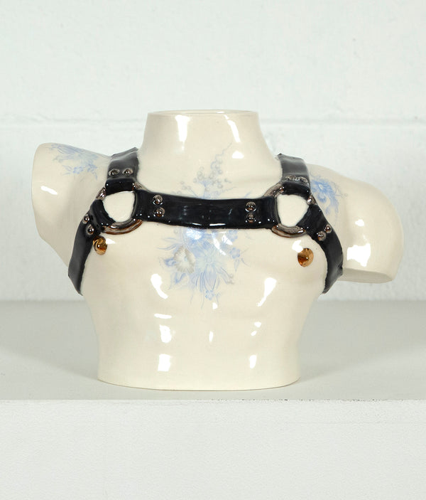 This is a ceramic vase for sale from Caviar20. Made by Pansy Ass and represents a torso with a leather harness.