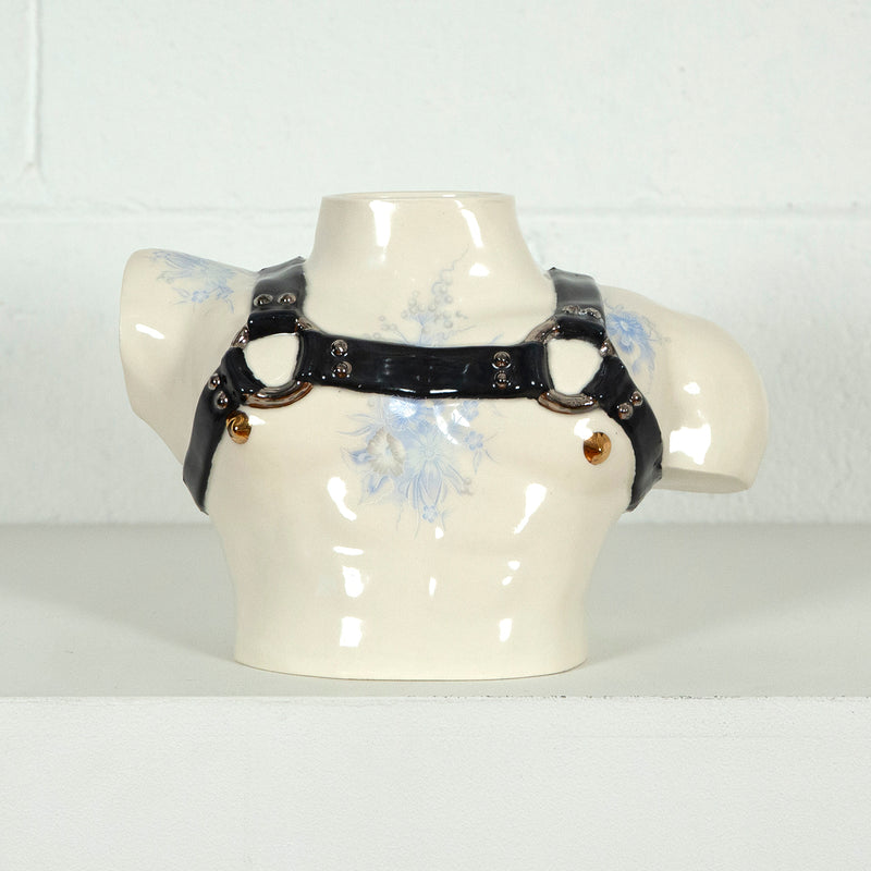 This is a ceramic vase for sale from Caviar20. Made by Pansy Ass and represents a torso with a leather harness.