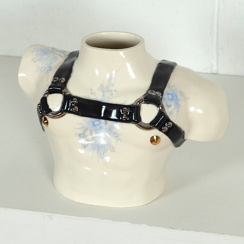 This is a ceramic vase for sale from Caviar20. Made by Pansy Ass and represents a torso with a leather harness.