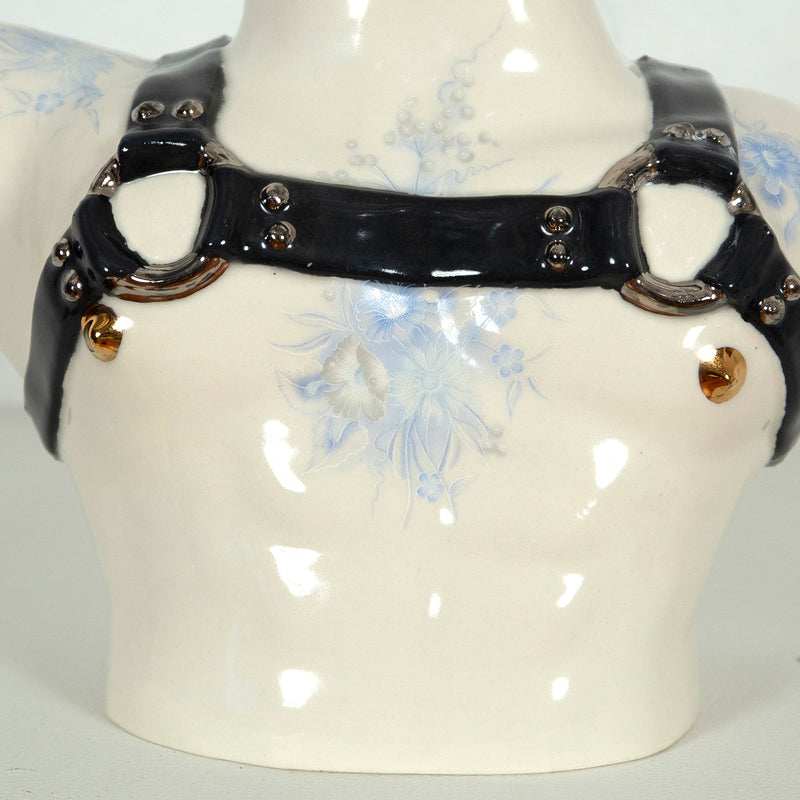 This is a ceramic vase for sale from Caviar20. Made by Pansy Ass and represents a torso with a leather harness.