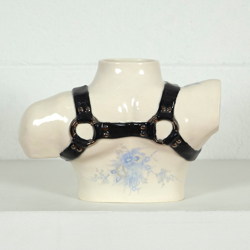 This is a ceramic vase for sale from Caviar20. Made by Pansy Ass and represents a torso with a leather harness.